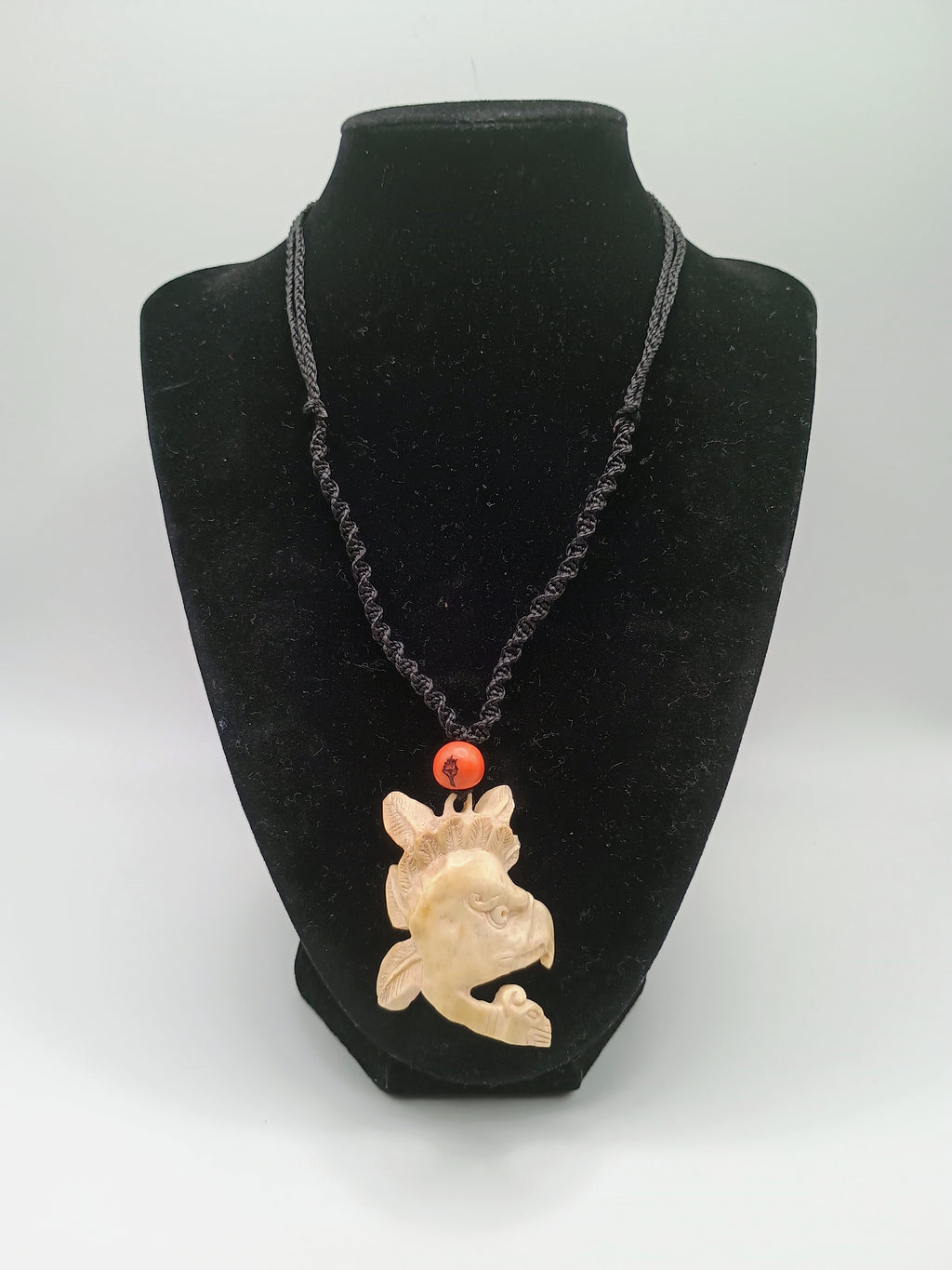 This unique, hand-carved bone pendant necklace features a stunning pendant craft