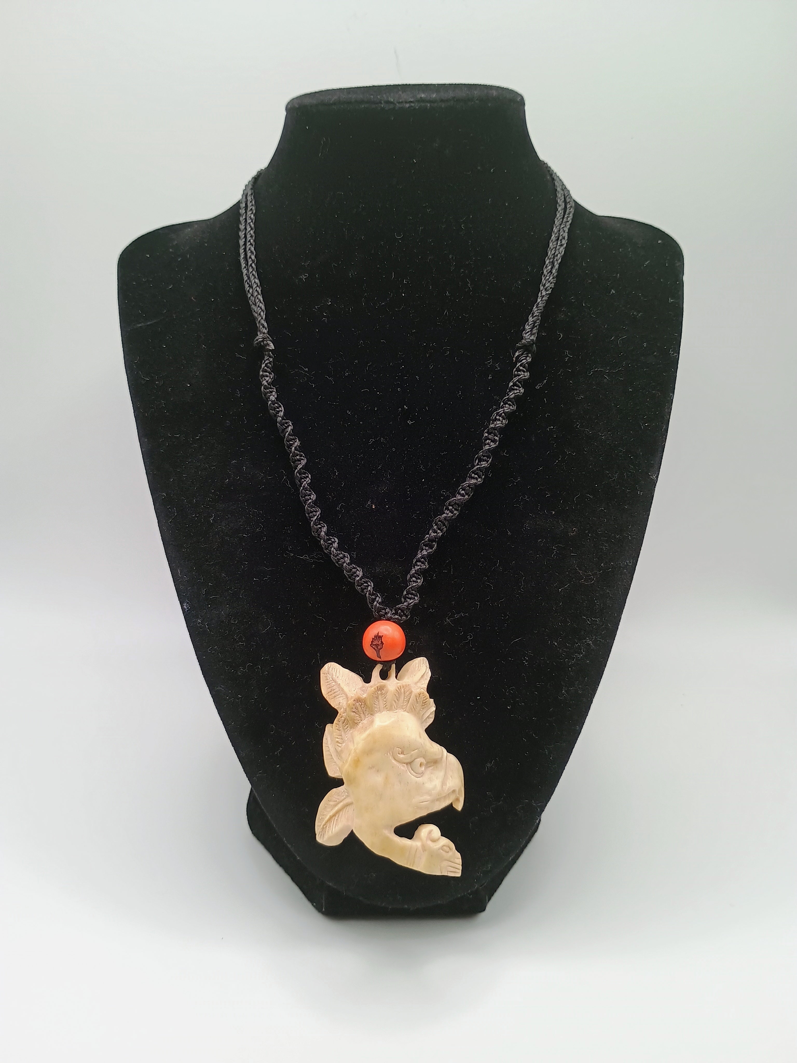 This unique, hand-carved bone pendant necklace features a stunning pendant craft