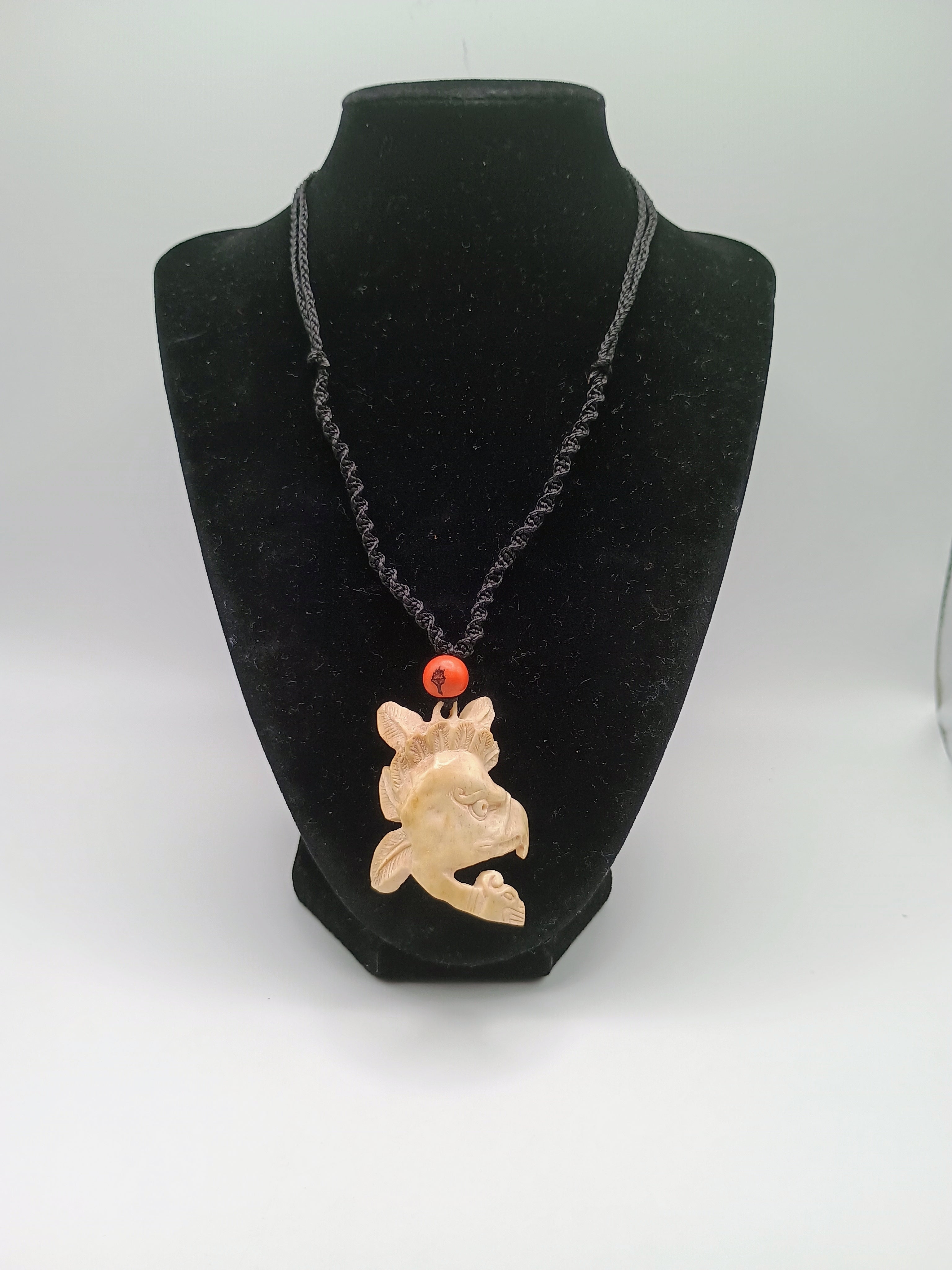 This unique, hand-carved bone pendant necklace features a stunning pendant craft