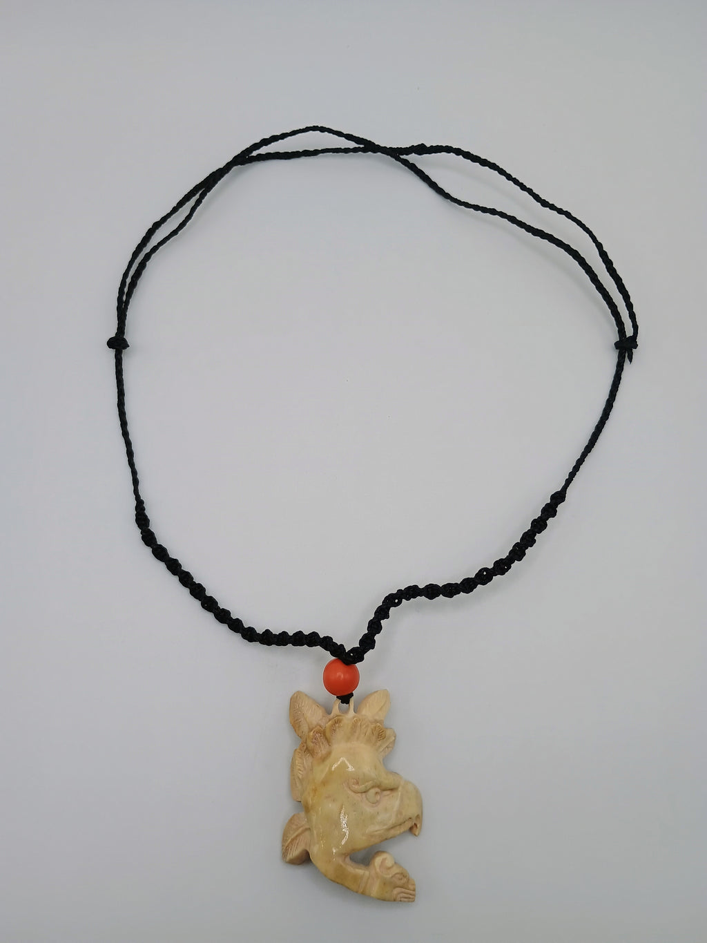 This unique, hand-carved bone pendant necklace features a stunning pendant craft