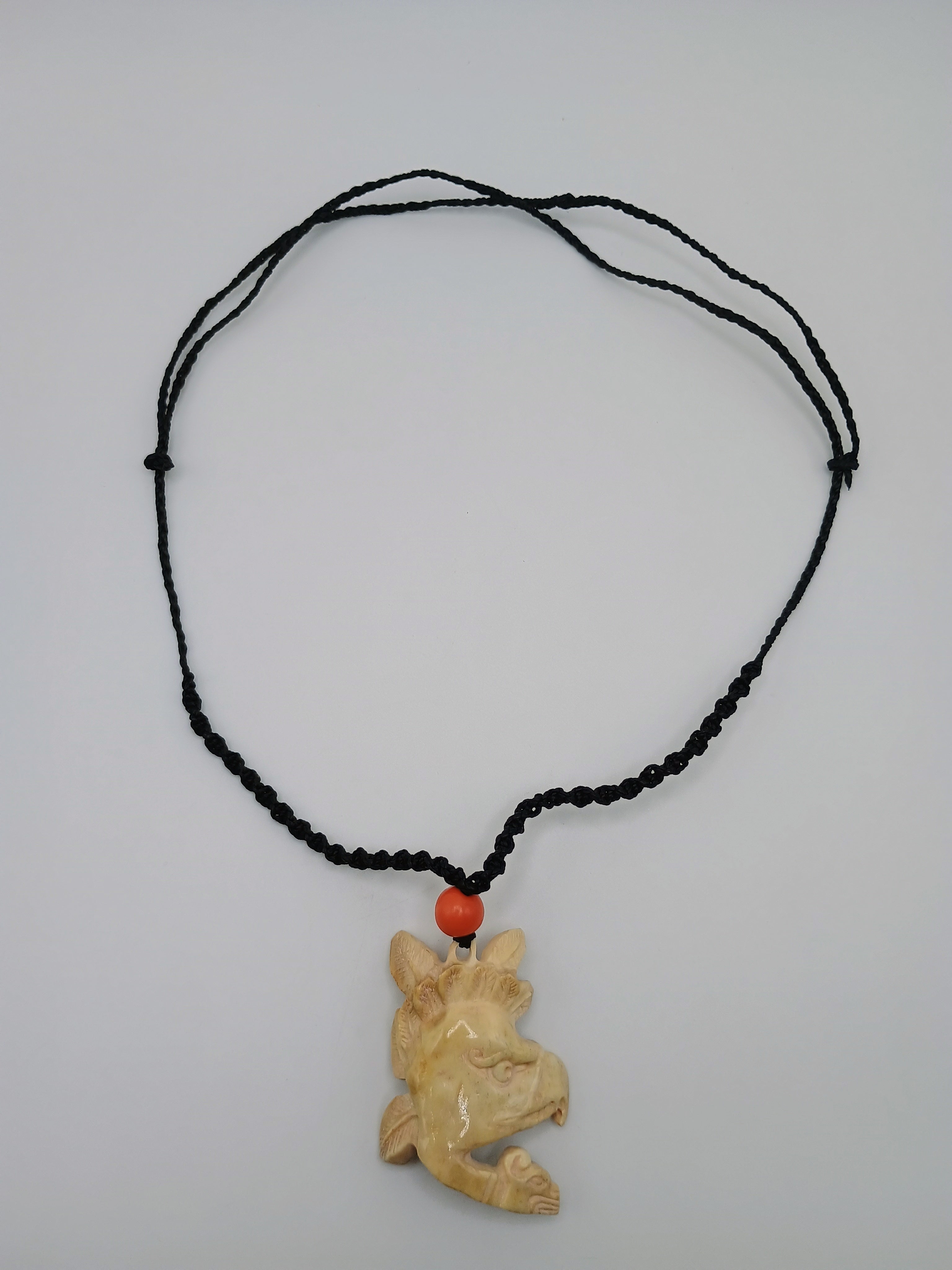 This unique, hand-carved bone pendant necklace features a stunning pendant craft