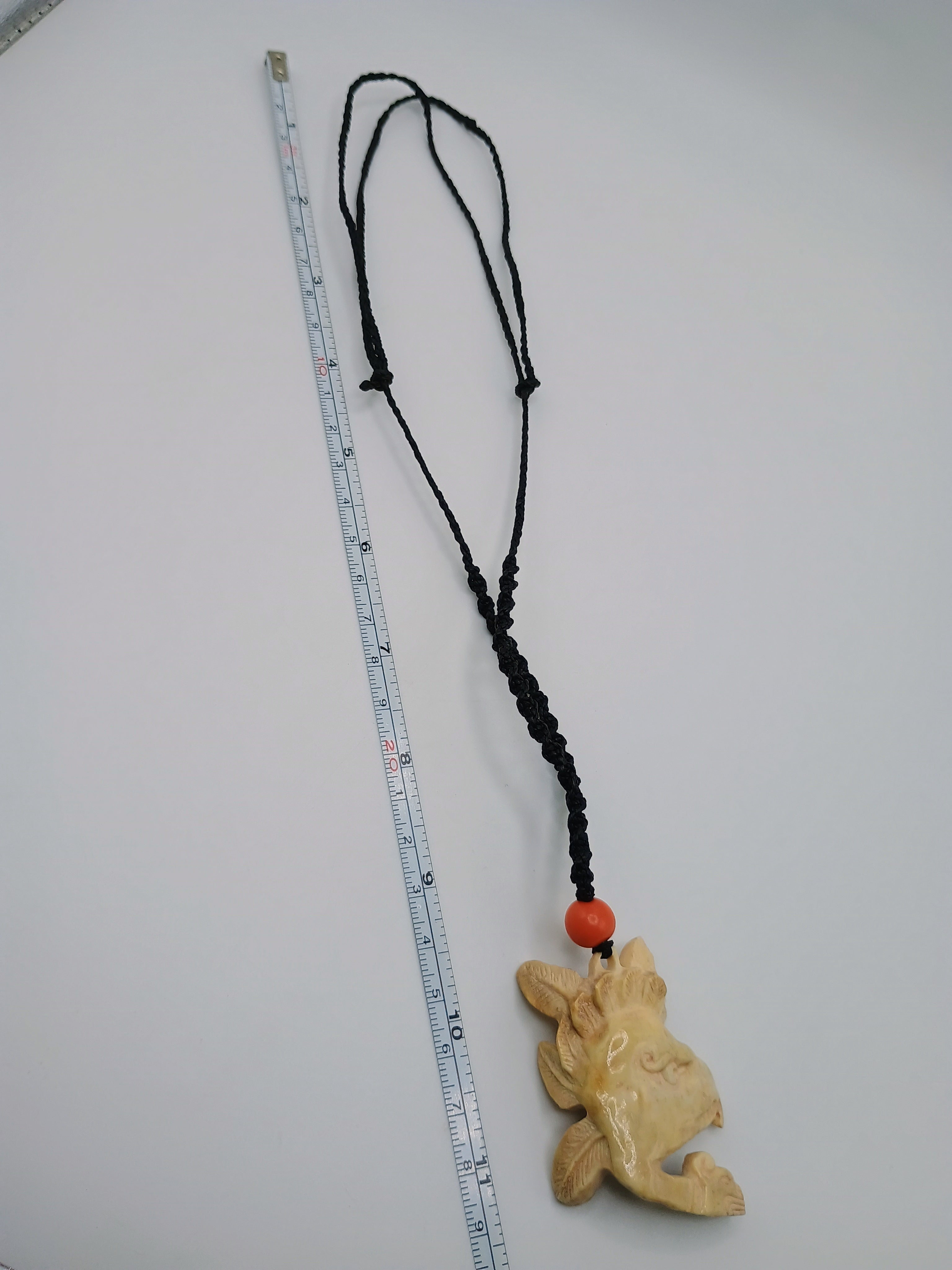 This unique, hand-carved bone pendant necklace features a stunning pendant craft