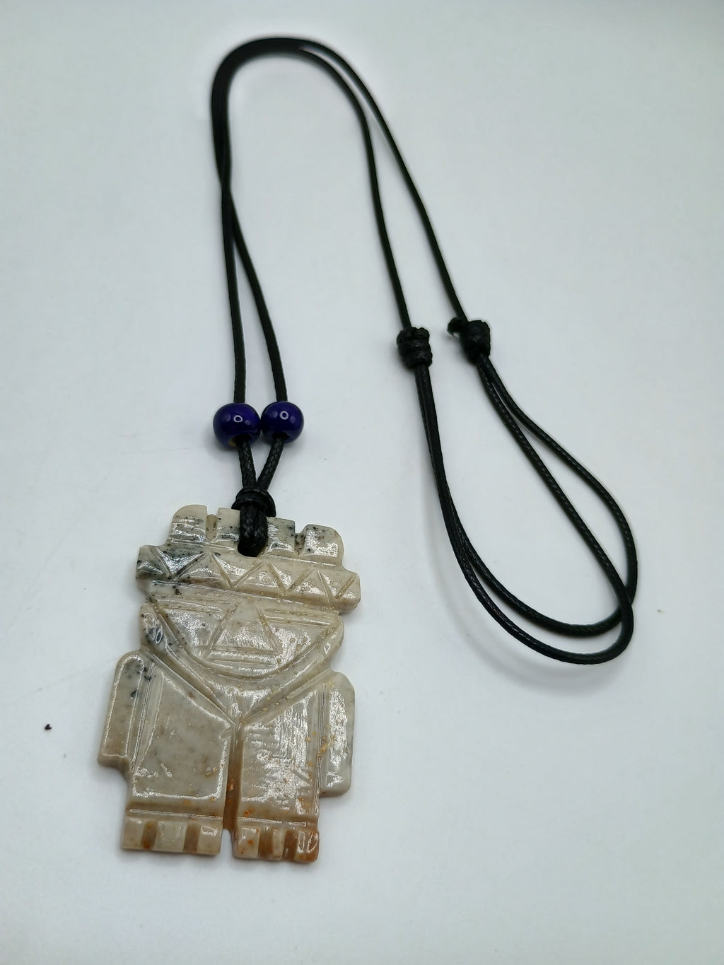 Hand-carved natural stone necklace with an ancestral style pendant and adjustable cord.