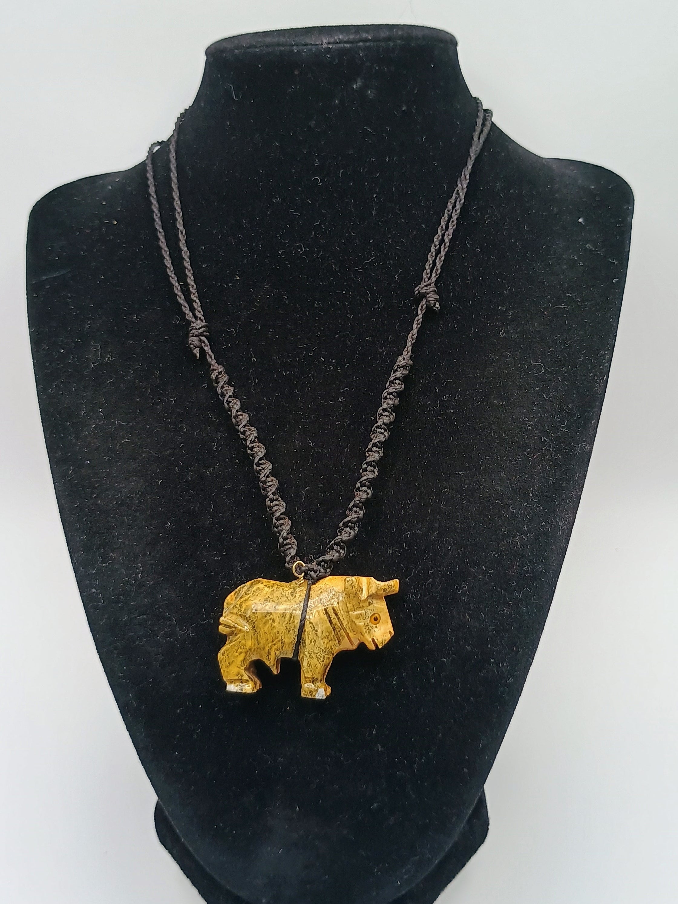 Hand-carved Palo Santo necklace with a handmade bull pendant, amulet for strength and protection.