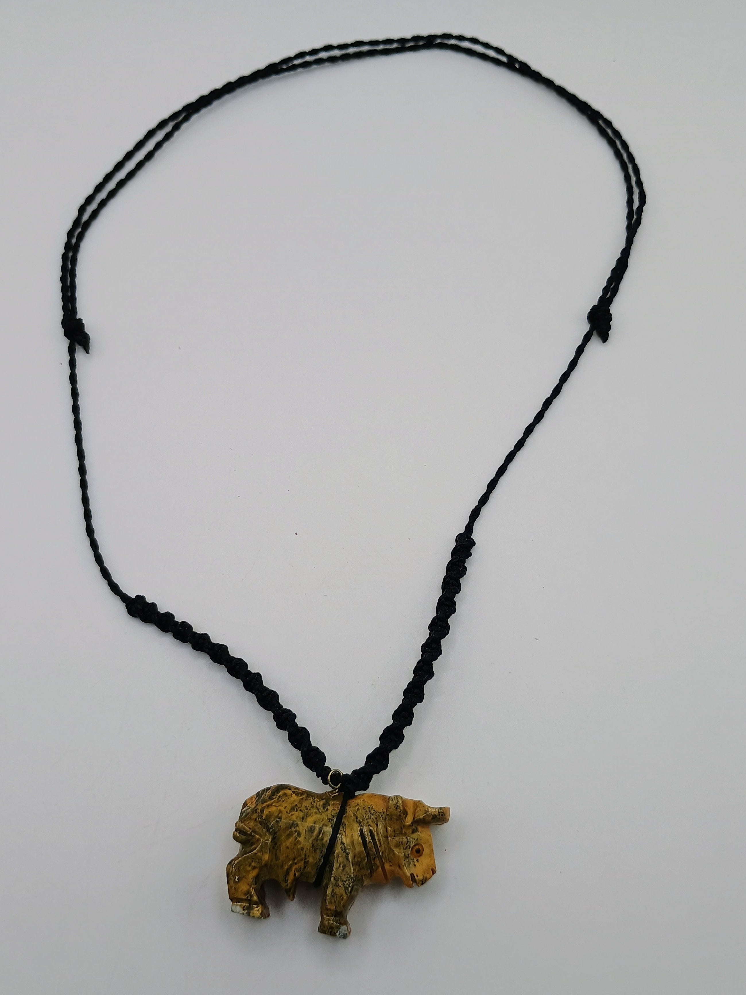 Hand-carved Palo Santo necklace with a handmade bull pendant, amulet for strength and protection.