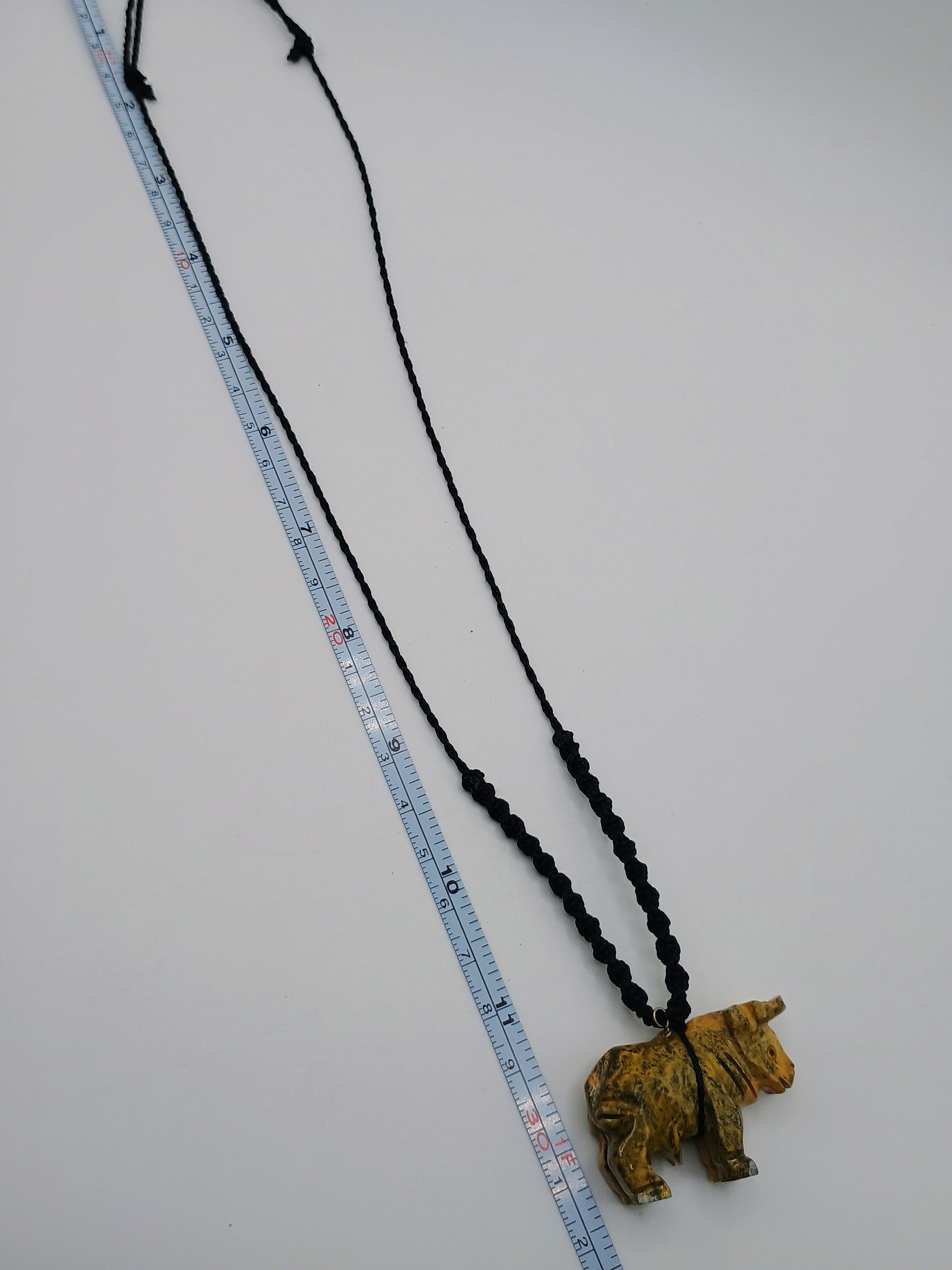 Hand-carved Palo Santo necklace with a handmade bull pendant, amulet for strength and protection.