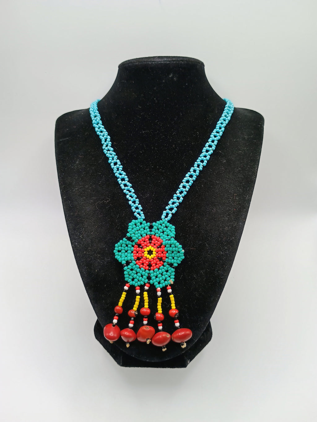 Hand-woven flower necklace with multicolored beads and natural seeds