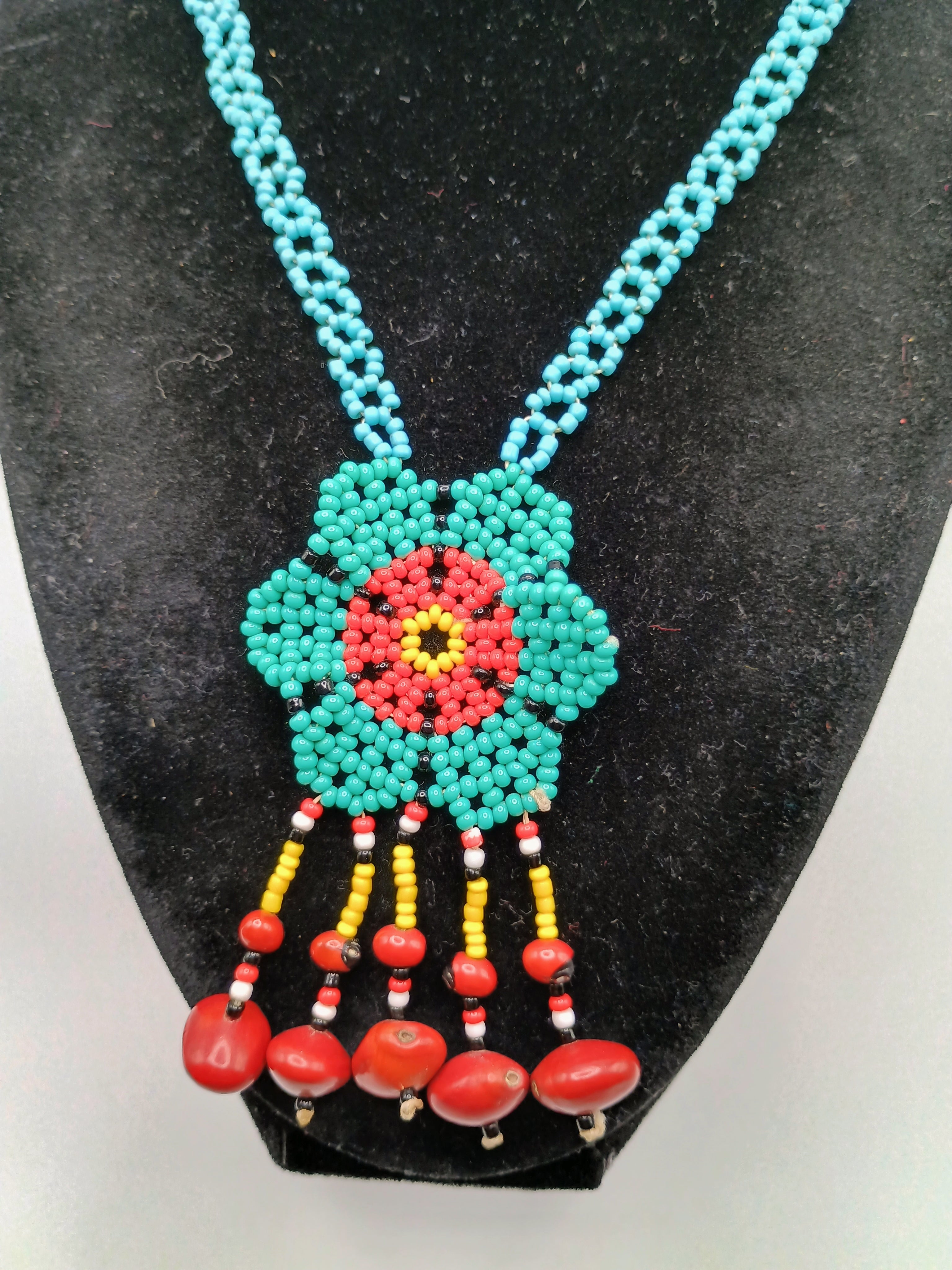 Hand-woven flower necklace with multicolored beads and natural seeds