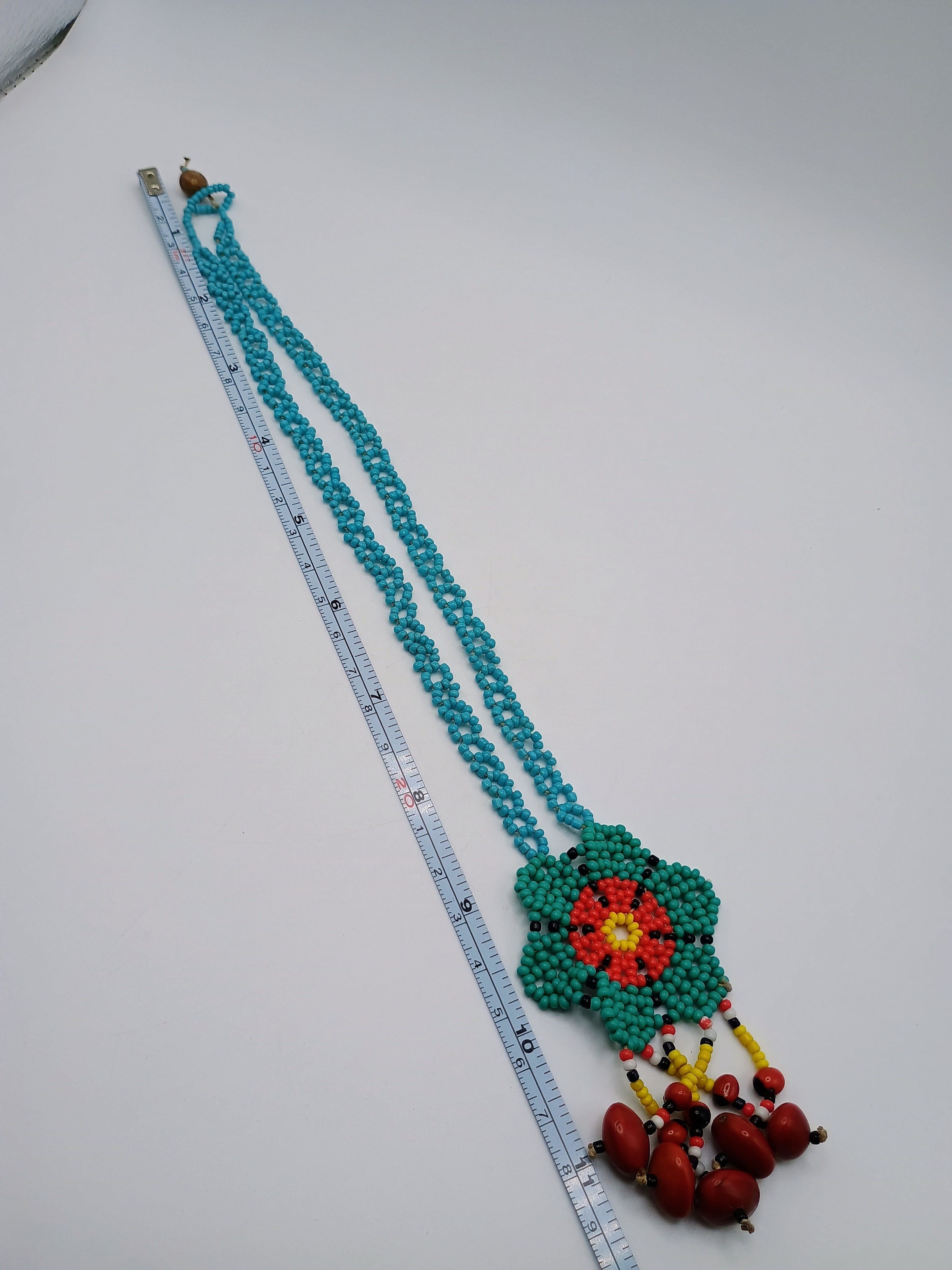Hand-woven flower necklace with multicolored beads and natural seeds