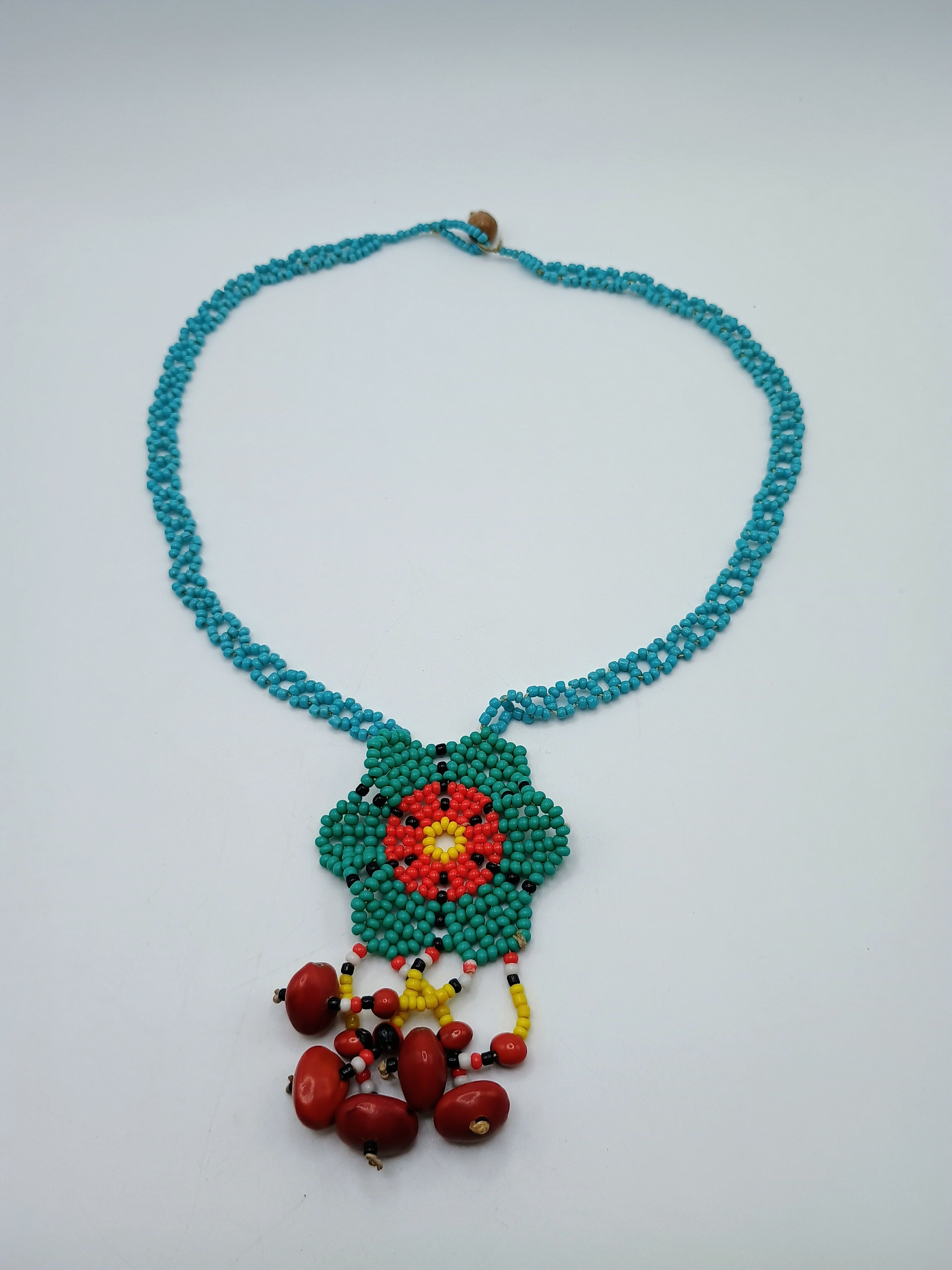 Hand-woven flower necklace with multicolored beads and natural seeds